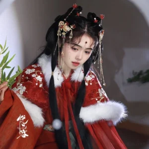 Model wearing red embroidered Hanfu with festive Chinese lantern tassel hair pins in a traditional bridal-inspired updo