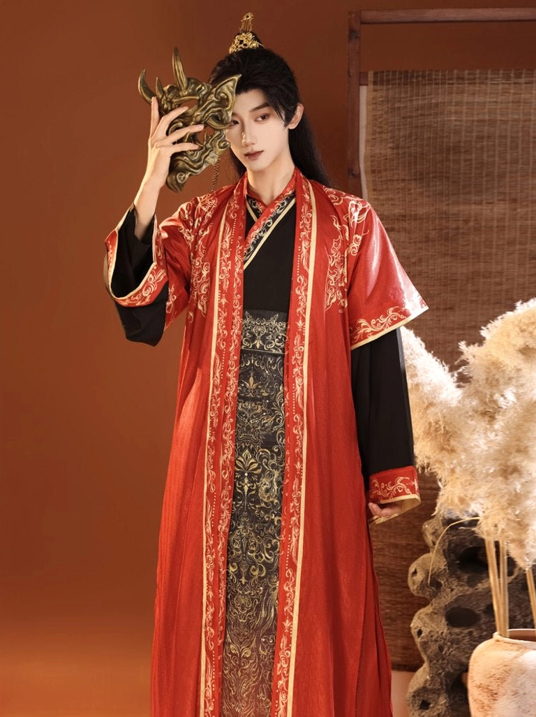 Red Chinese fantasy hanfu for men with ornate gold borders, black layered inner garment and patterned ceremonial waist decoration
