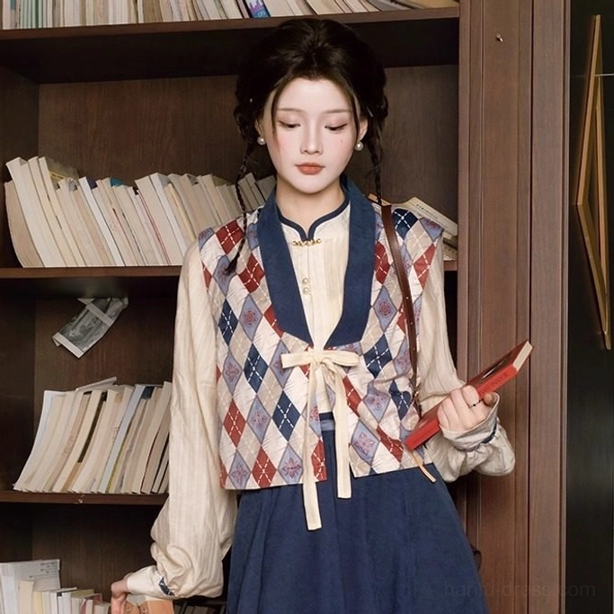 Front close up of red navy and off white modern Hanfu outfit with patterned vest, soft lantern sleeves, and elegant Chinese inspired styling