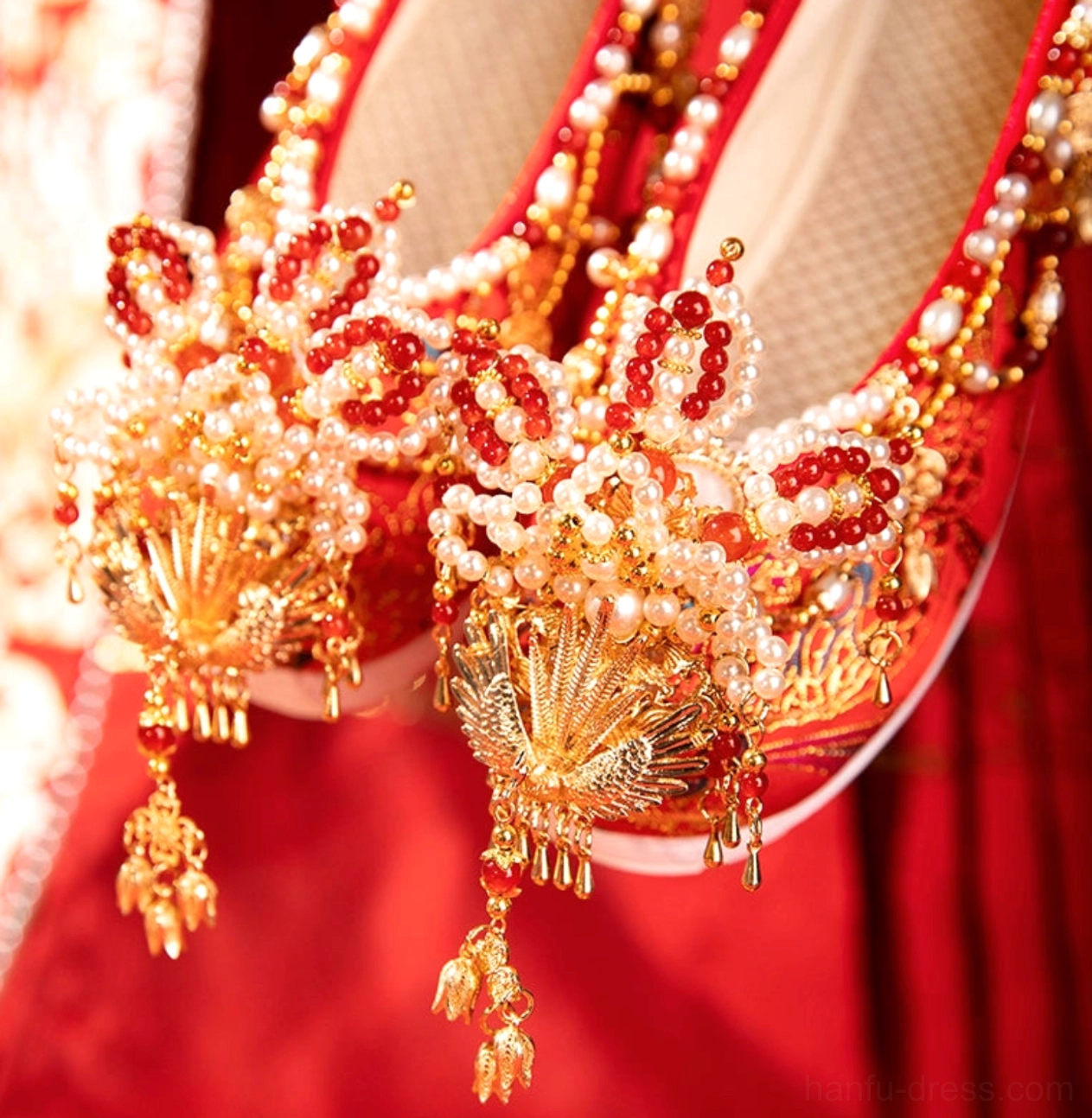 Close-up of phoenix ornament pearl beads red tassels and breathable mesh interior on Chinese wedding Hanfu shoes