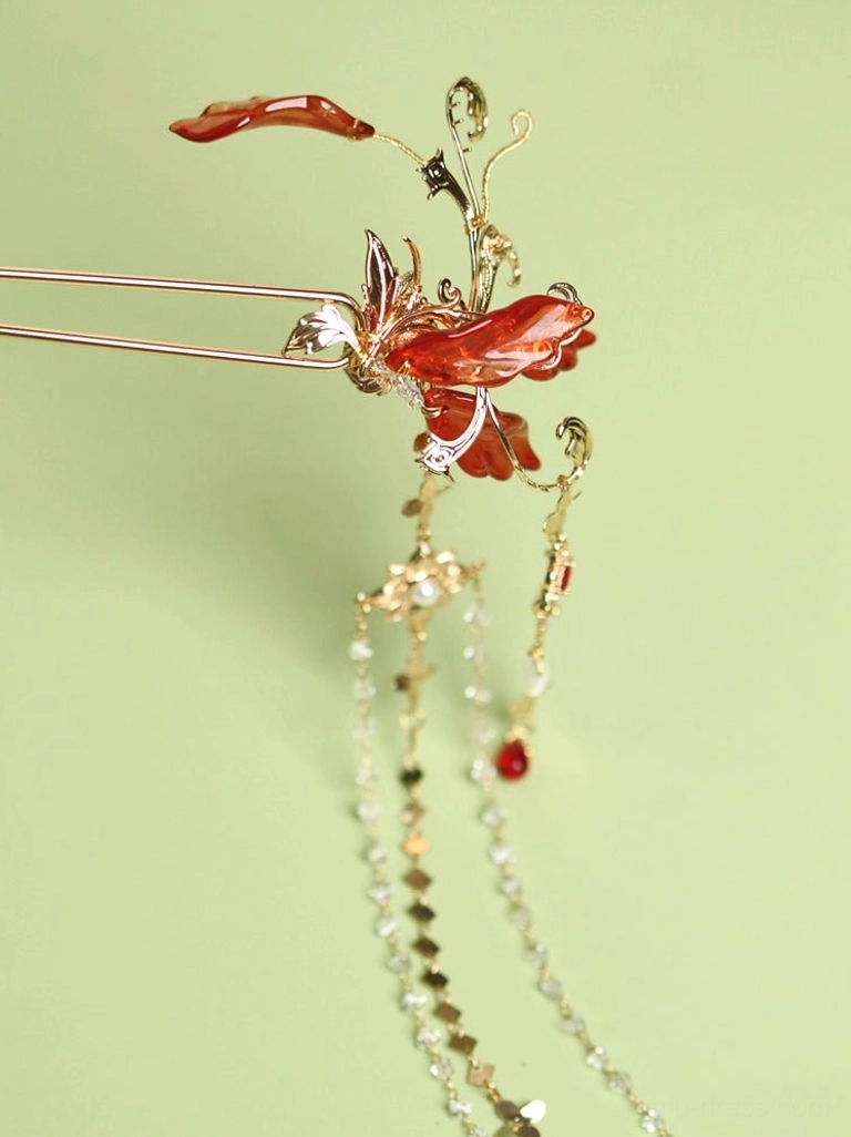 Left-side profile of red spider lily Chinese hair pin showing double-prong hairpin shaft, symmetrical red floral ornament, gold-tone chains, and crystal tassels