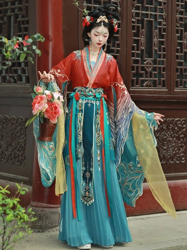 Red Wei Jin Dynasty Qiyao Ruqun Hanfu full set with teal embroidered flowing sleeves, teal pleated skirt, waist ornaments, and traditional Chinese styling in a garden pavilion