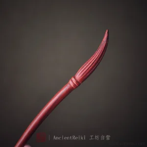 Reddish brown ink brush Chinese hair stick with carved bristle tip on dark background for Hanfu hairstyles