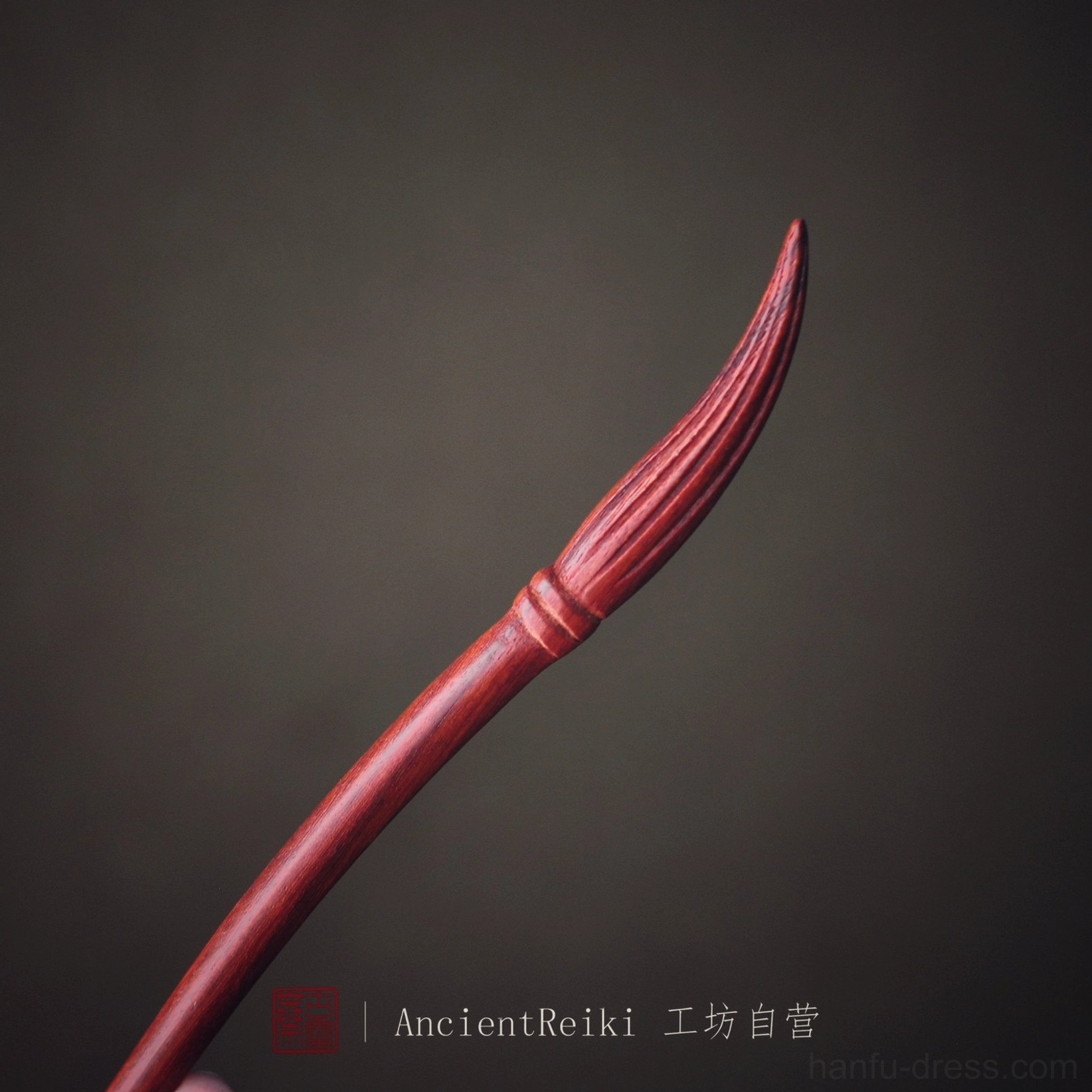 Reddish brown ink brush Chinese hair stick with carved bristle tip on dark background for Hanfu hairstyles