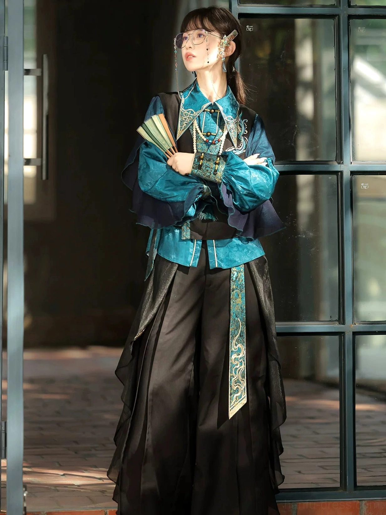 Women’s retro Chinese style Hanfu pants set with dark embroidered vest, ruffled sheer sleeves, and folding fan