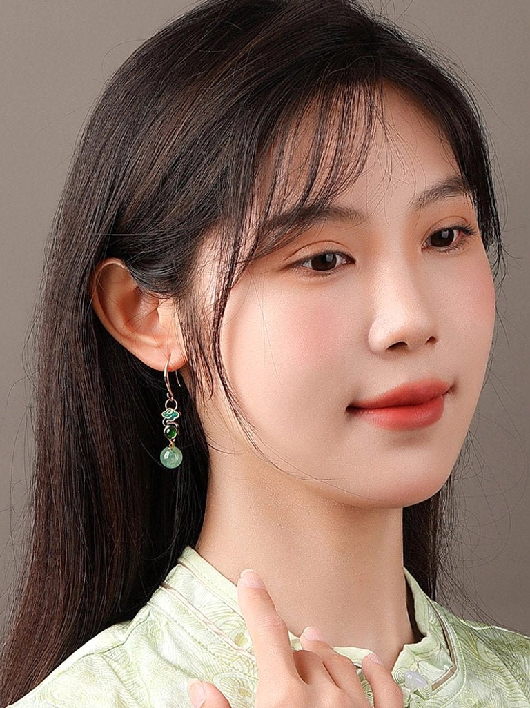 Front portrait of model wearing delicate Rising Clouds Chinese drop earrings with colorful cloud and wave decoration for Cheongsam styling