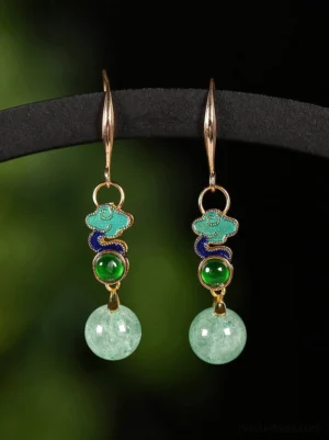 Rising Clouds Chinese drop earrings displayed on a black stand with gold hooks, colorful cloud motifs, green accents, and pale green bead pendants