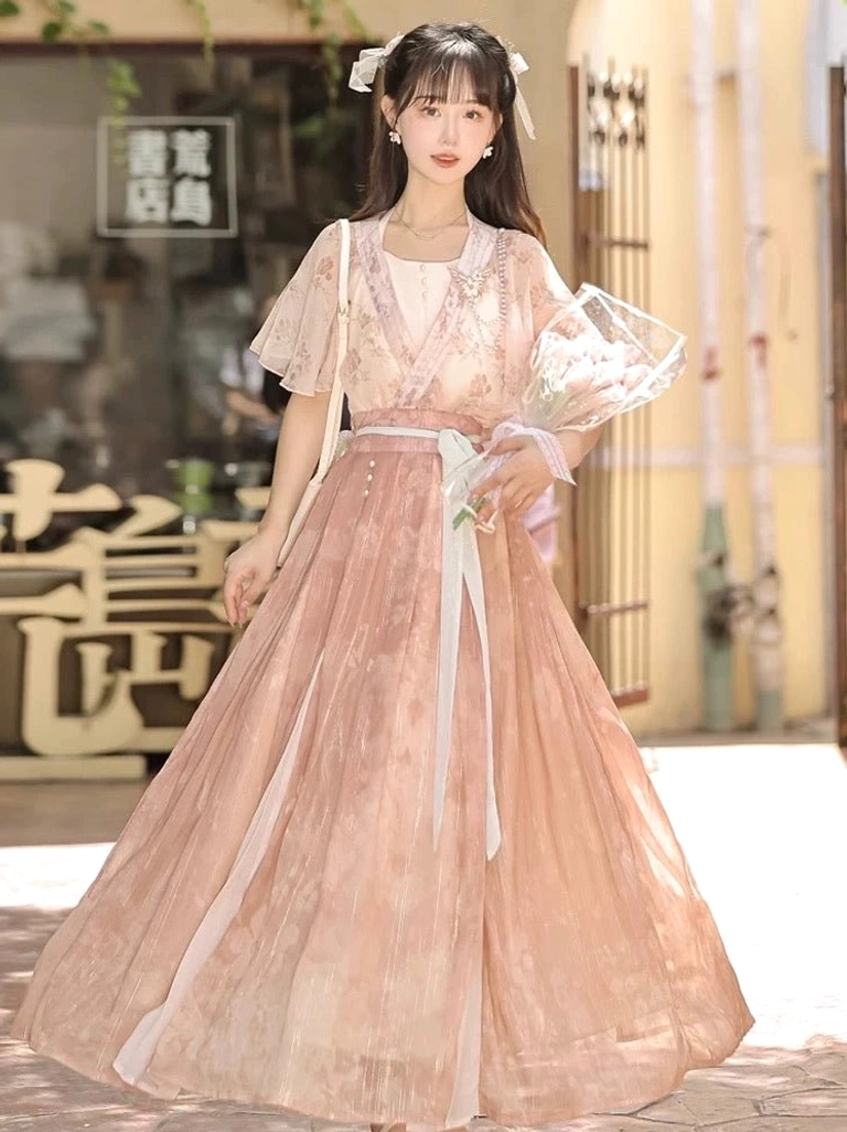 Full front view of a romantic modern Hanfu outfit with flutter sleeves cross V-neck floral top floor length skirt and light blue waist ribbon
