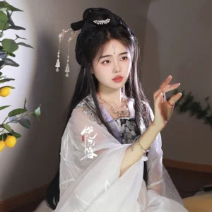 Female model wearing Rose Covenant crystal tassel Hanfu hairpin with a flowing white traditional Chinese Hanfu outfit