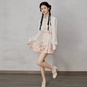Three-quarter view of modern Ming-inspired Hanfu blouse and pleated pink horse face skirt with gold rose hem motifs