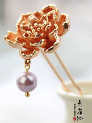 Front close-up of dual-prong rose gold peony Hanfu hair stick with detailed petals and purple dangling pendant