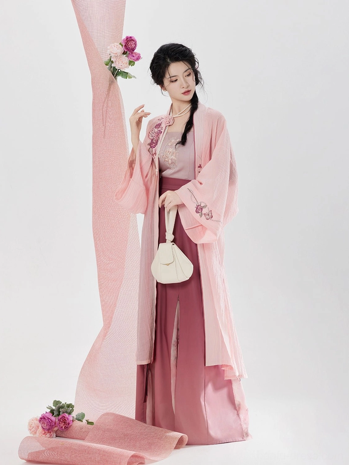 Side view of modern Song Dynasty hanfu clothing with pink embroidered beizi collar coordinated camisole and flowing floral wrap skirt