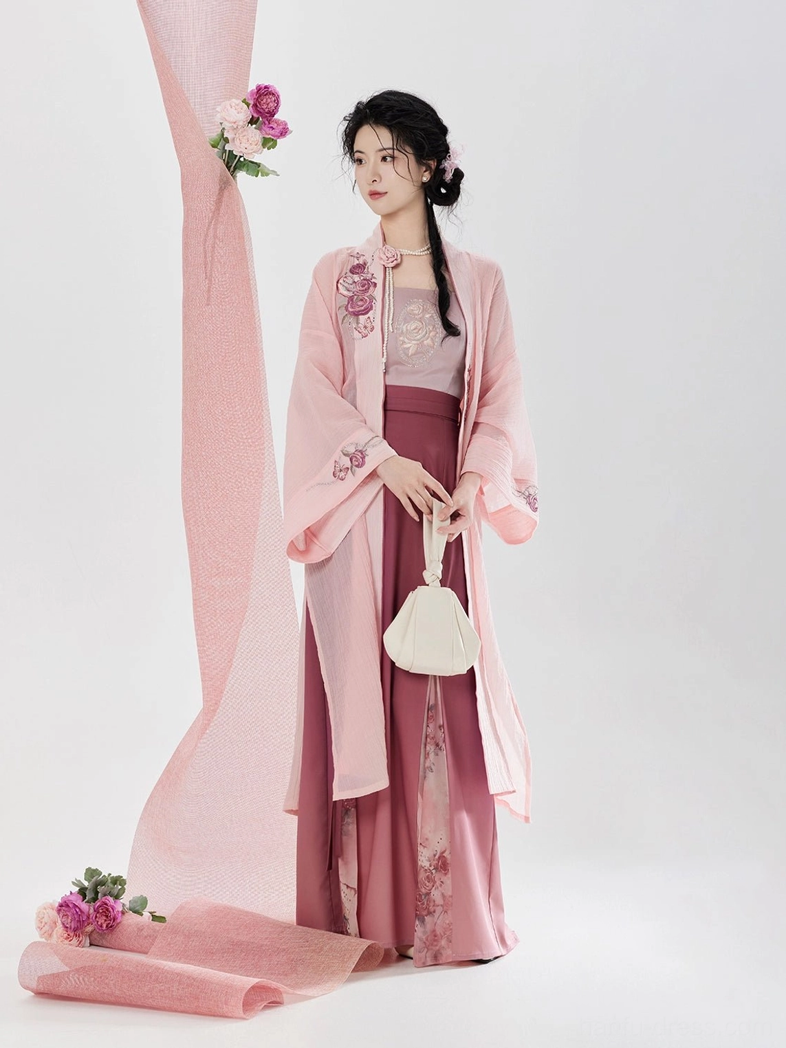 Front view of romantic rose pink Song Dynasty hanfu set featuring delicate floral embroidery on the outer beizi jacket and modern layered styling