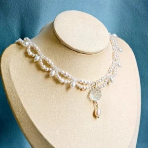 Translucent rose freshwater pearl Hanfu yingluo choker necklace displayed on jewelry mannequin with teardrop pearl pendant