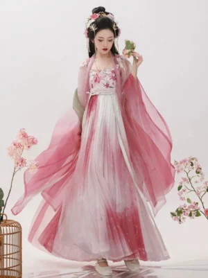 Front full-body view of a rose pink Tang Dynasty Hanfu Heziqun dress with ombre pink to white skirt, floral embroidered bust, sheer wide sleeves, and traditional flower hair ornaments