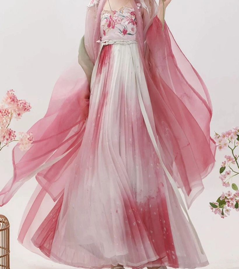 Full-length view of a rose pink and white ombre Tang Dynasty Hanfu Heziqun dress displayed with embroidered bust section, sheer wide-sleeved coat, and floral studio backdrop
