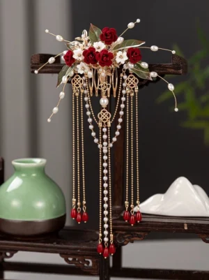 Rosewood burgundy rose Chinese bridal back hair pin comb with pearl tassels, gold chain pendants, white flowers, green leaves and traditional coin accents