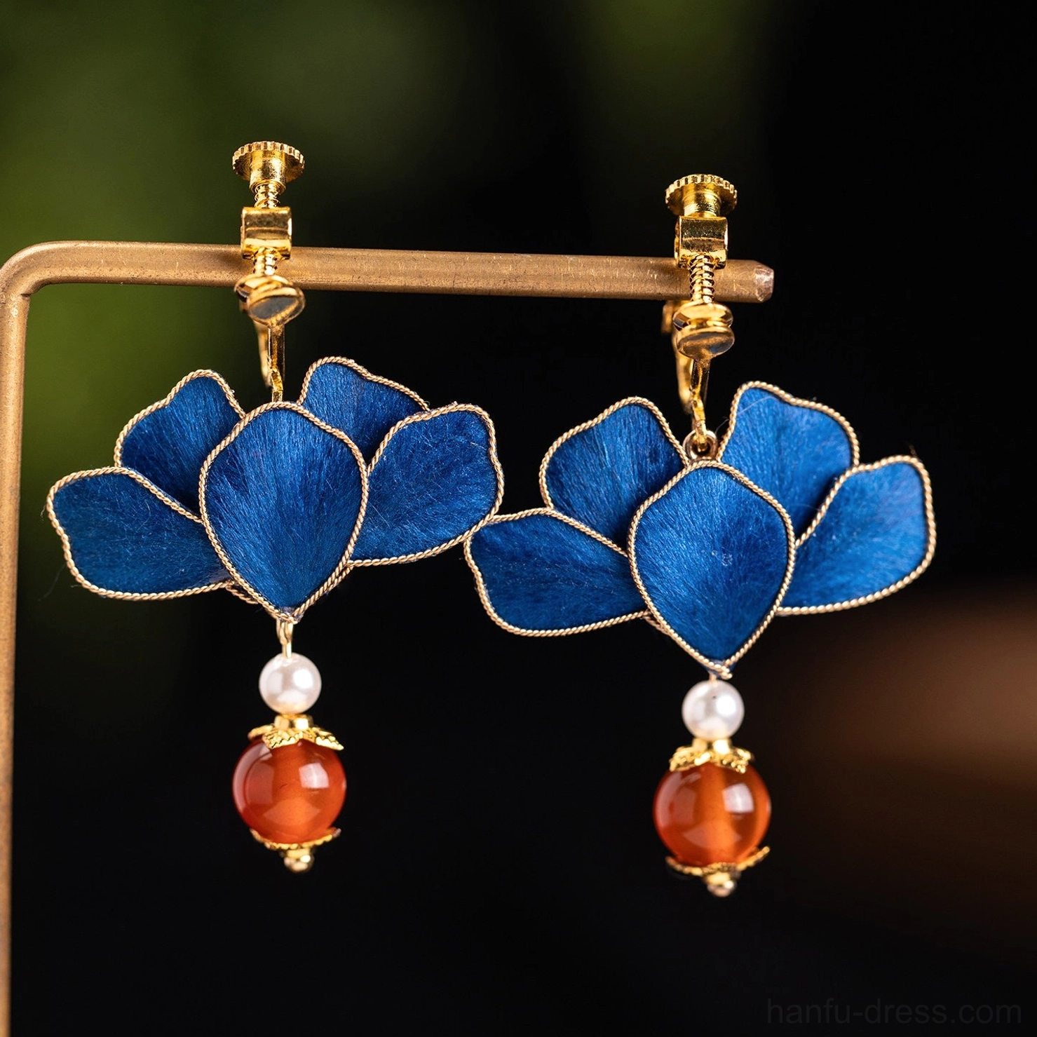 Royal blue lotus comfort clip-on Chinese earrings with gold screw-back clips, pearl accents and red agate-style drops