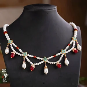 Front view of a Dunhuang style Hanfu necklace with freshwater pearl strands, red agate accents, turquoise floral charms, teardrop pendants, gold-tone hardware, and tassel details