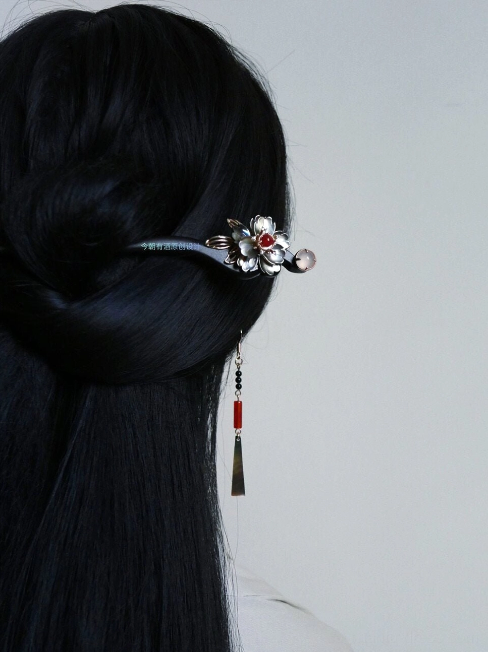 Model wearing ruby red shell Chinese drop earrings with a traditional Hanfu hairstyle and floral hairpin