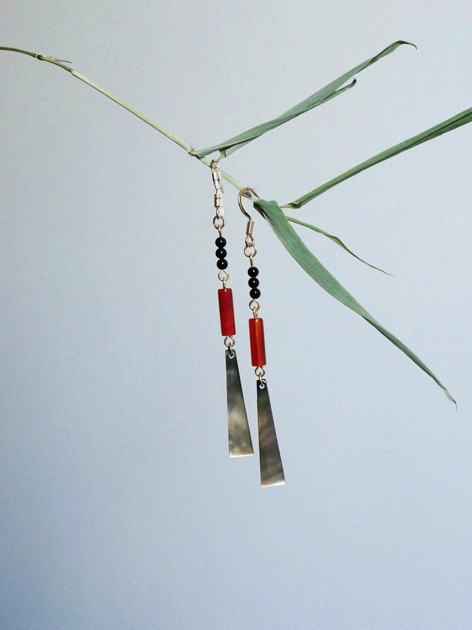 Detailed hanging view of ruby red bead and trapezoid shell Chinese earrings with gold-tone chains for Hanfu and Qipao
