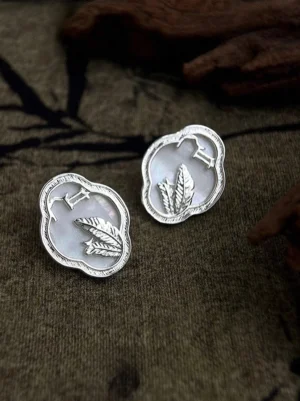 Ruyi mother-of-pearl pavilion stud earrings in Chinese Hanfu jewelry style displayed on linen with bamboo shadows