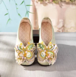 Pair of sage green traditional Chinese Hanfu shoes with sparkling butterfly toe decorations and checkered insoles front view
