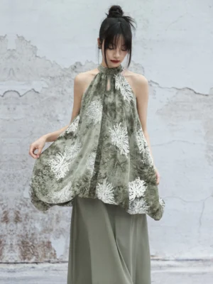Sage green modern Hanfu halter dress set with white chrysanthemum embroidery, flowing sleeveless top and matching long skirt shown from a front three-quarter view