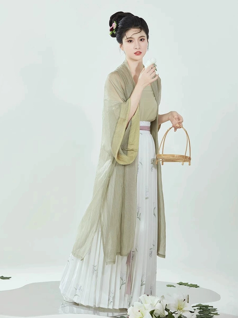 Full-body side view of a sage green Song Dynasty Hanfu set showing the long neat hem, layered camisole, flowing outer robe, and elegant silhouette