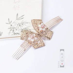 Two vintage inspired Chinese fan hair comb accessories displayed beside bamboo print stationery, featuring sakura flowers and pink pearls