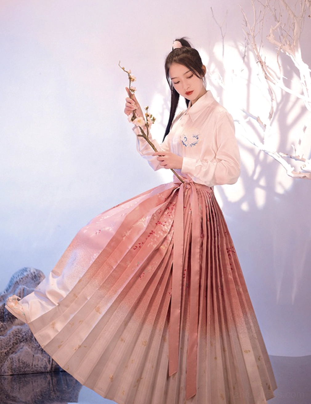 Modern Ming Dynasty Hanfu Sakura Mamianqun horse face skirt in pink to ivory ombre with floral print shown in a flowing side view