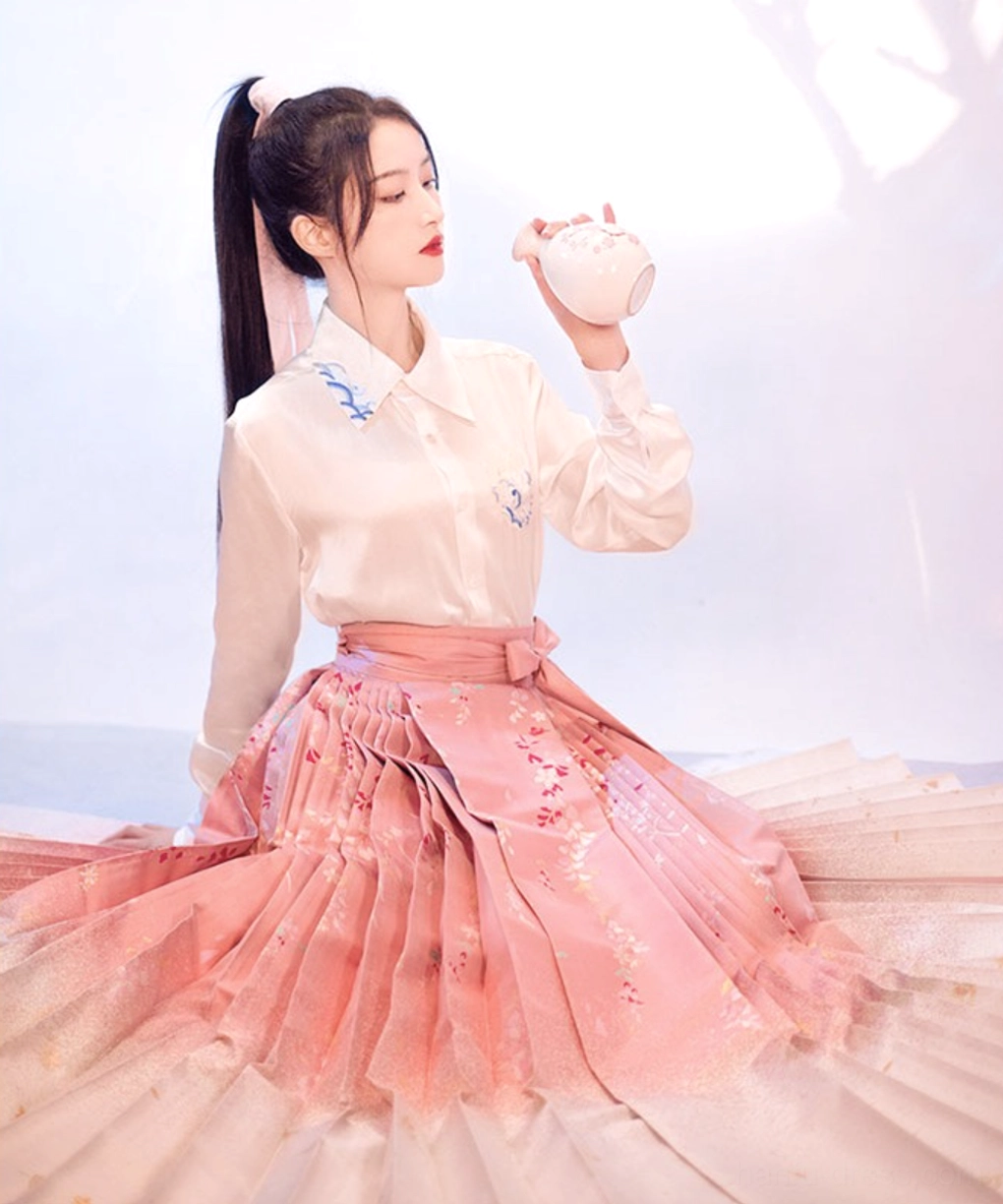 Sakura print Mamianqun horse face skirt in a seated modern Hanfu styling with wide pink beige ombre pleats and embroidered blouse