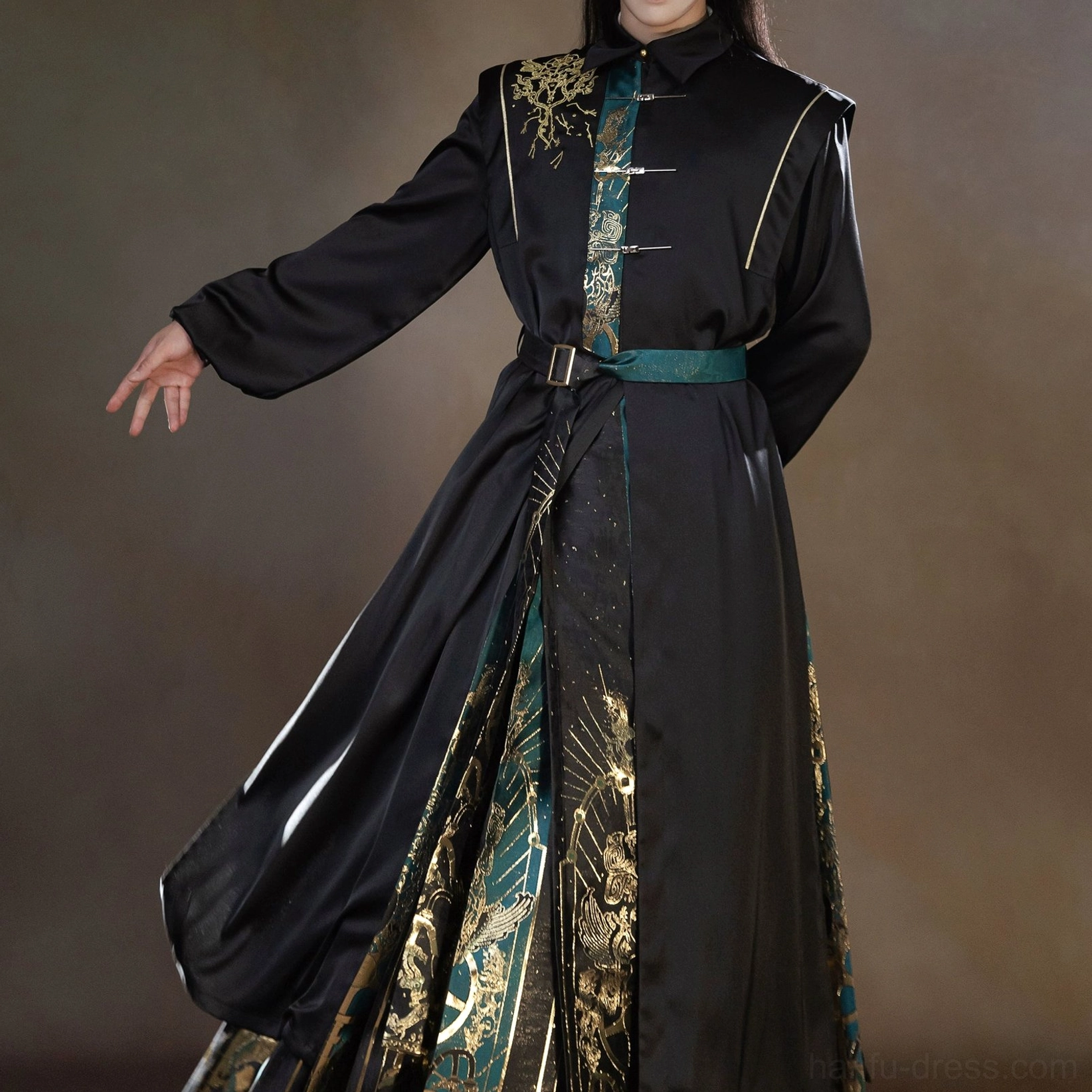 Standalone Sanxingdui Hanfu robe with black stand collar, gold shoulder embroidery, green trim, matching waist belt, and patterned hem