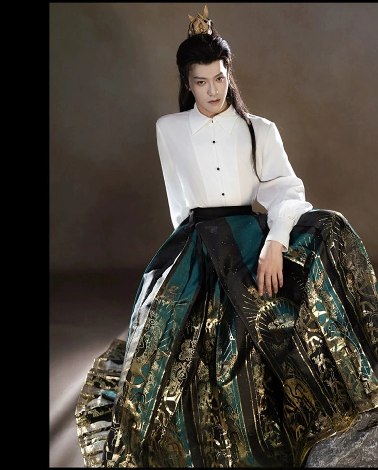 Close view of a white Chinese stand collar shirt and intricate dark green gold Sanxingdui patterns on a traditional mamianqun horse face skirt