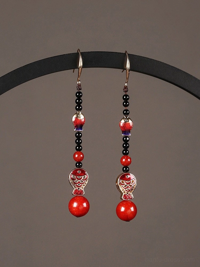 Scarlet koi fish Chinese earrings displayed on a black stand with red black and gold enamel details for cheongsam and Hanfu styling