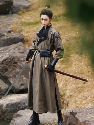 Front three-quarter view of male model wearing Scorpio Tang style Hanfu robe set with belt bracers and sword