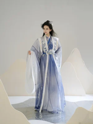 Sea Lilies blue and white gradient Xianxia hanfu set with wide sleeves floral embroidery and decorative waist accessory shown in a full body three quarter view