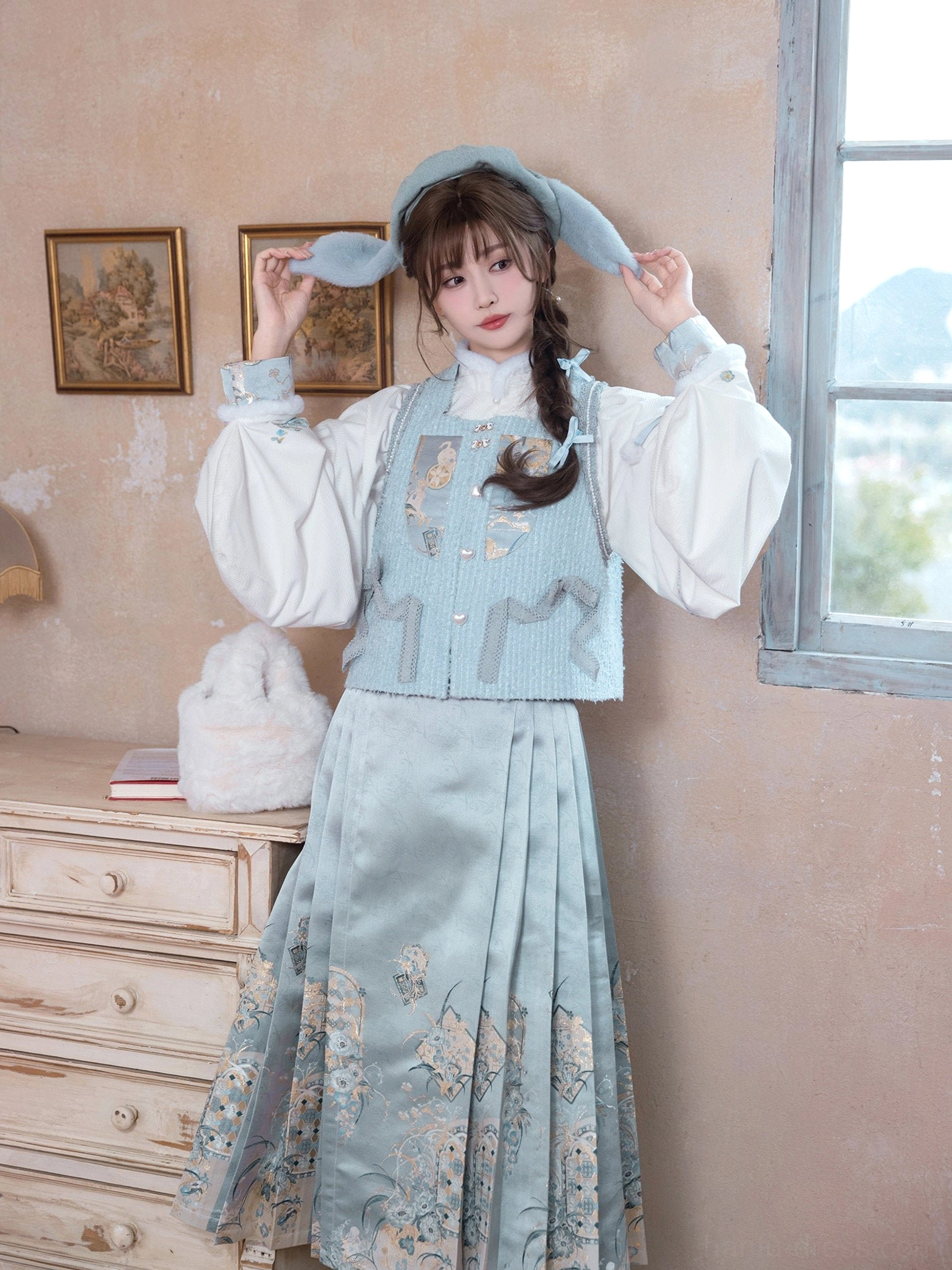 Side view of Sea Salt Cream Ming-inspired Hanfu outfit with embroidered bijia vest and light blue mamianqun skirt