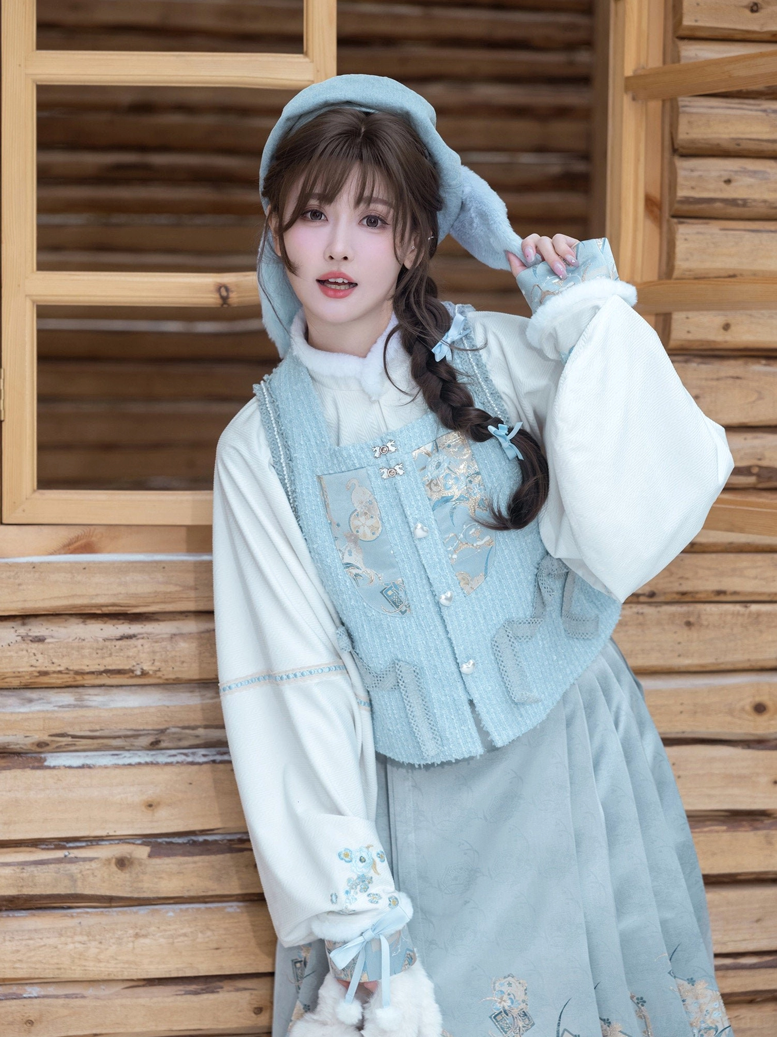 Side close-up of modern Ming Hanfu Sea Salt Cream outfit showing bow cuff embroidery and light cyan bijia vest