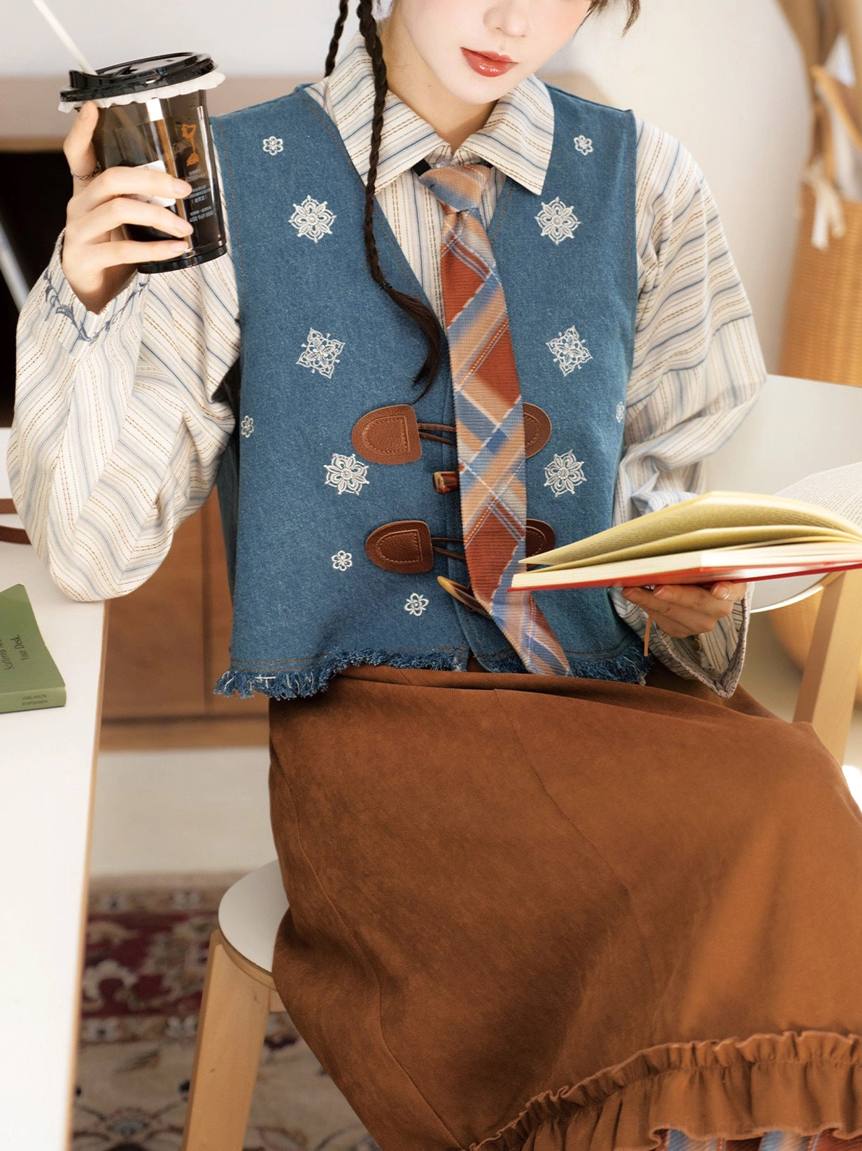 Close up of Sea Salt Mocha modern hanfu outfit showing horn toggle embroidered vest striped top and matching plaid necktie