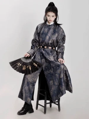 Gender-neutral reversible Hanfu coat with marbled jacquard texture styled in a dark Chinese wuxia fashion look with folding fan