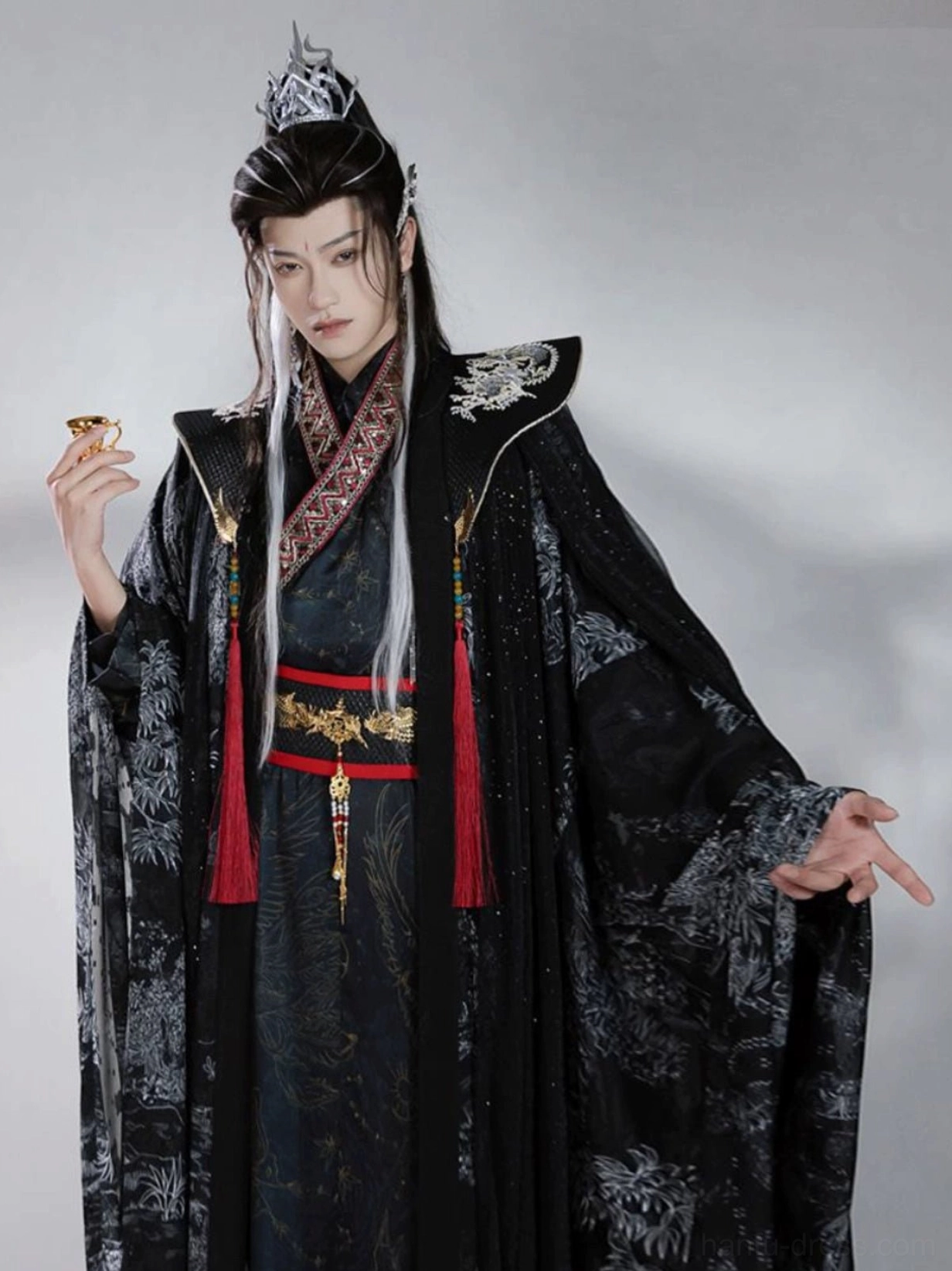 Men's black Xianxia Hanfu costume front view featuring translucent printed cloak, cross-collar robe, silver cloud shoulders, and red tassel waist sash