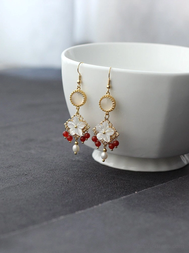 Oriental shell flower pearl drop earrings with gold tone metalwork red bead accents and white floral charms