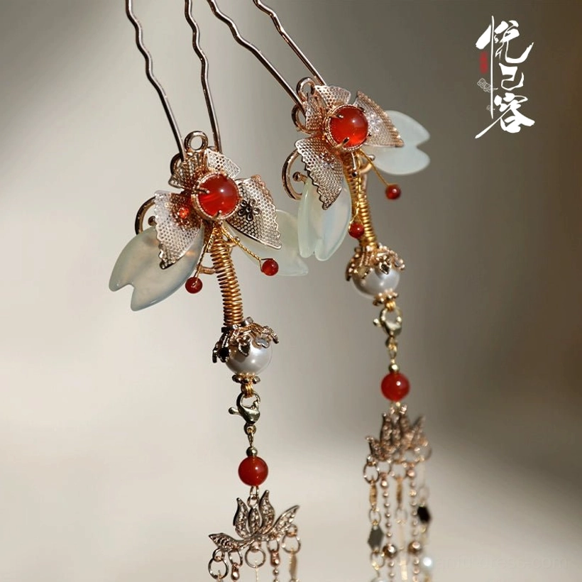 Close-up of Chinese butterfly tassel hairpins featuring gold-tone metal, red beads and white jade-like floral details