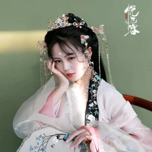 Model wearing Shengzhao Chinese Hanfu tassel hairpins with a pink and white embroidered traditional outfit
