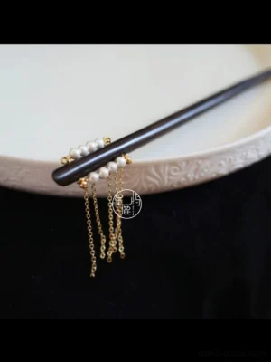 Side close-up of Shooting Stars Chinese hair stick featuring white imitation pearls and delicate gold tone tassel chains for Hanfu