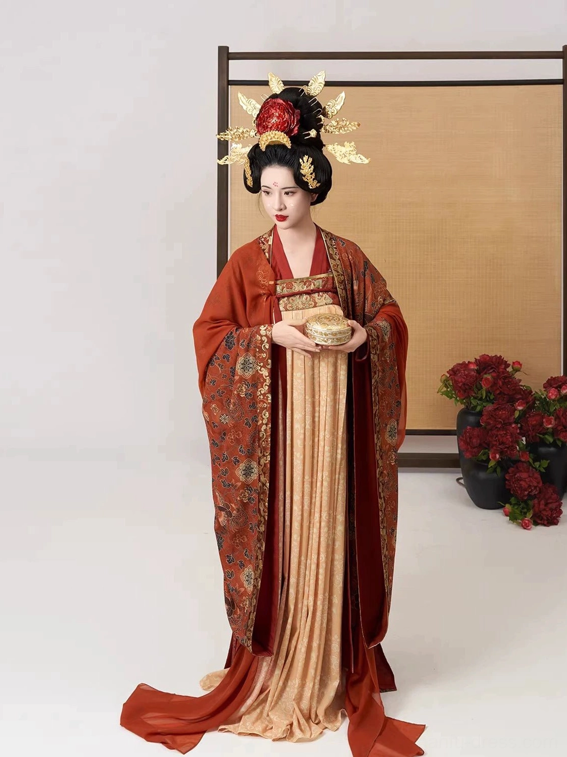 Front three-quarter view of the Shuangfengque Qixiong Ruqun Hanfu featuring a neat cross-collar top, warm brown and apricot palette, elegant trims, and Tang-style hair ornaments