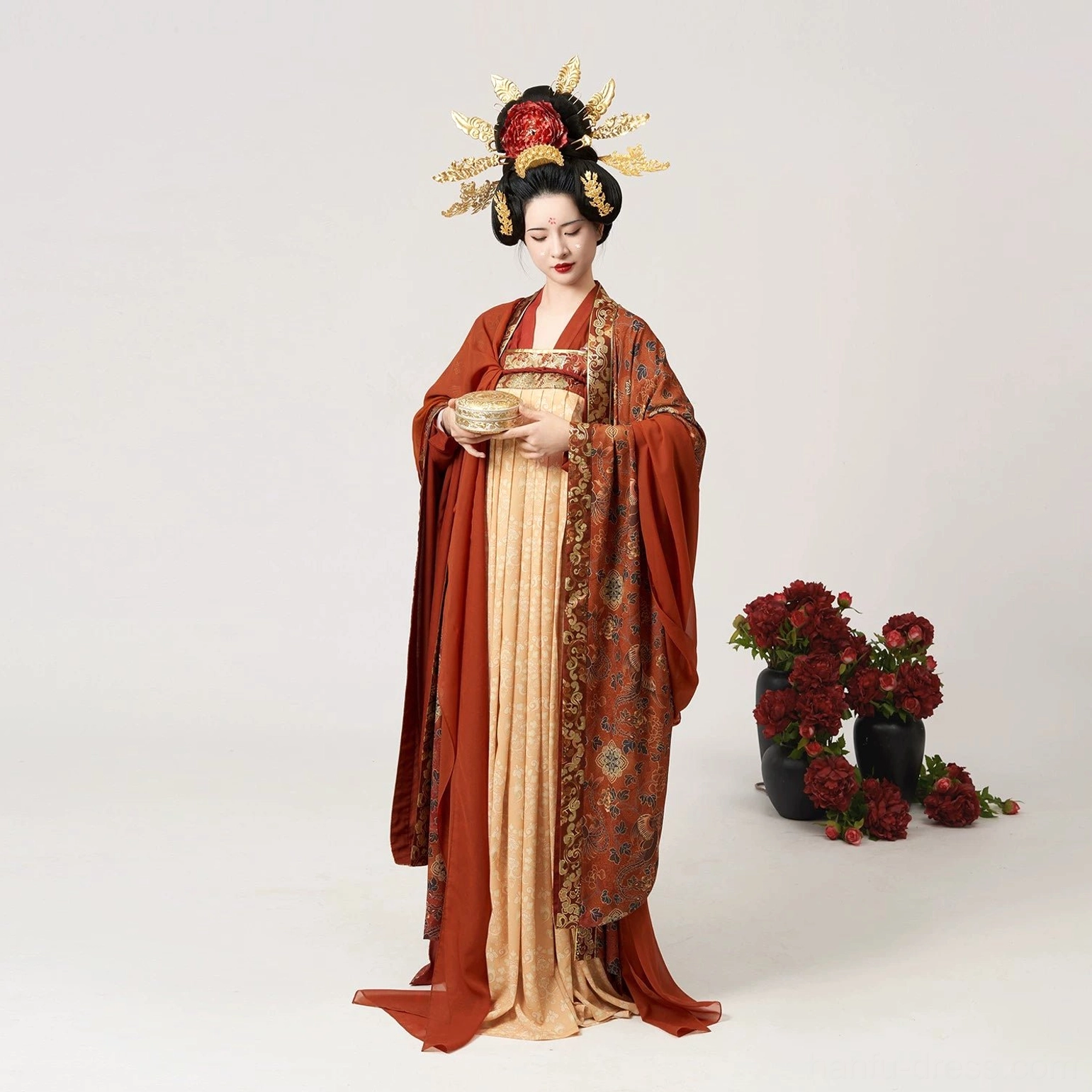 Low-angle front view of the Shuangfengque Tang Dynasty Qixiong Ruqun Hanfu with a grand Tang-style hair crown, flowing wide sleeves, fitted top, and warm royal color palette