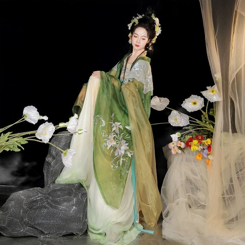 Side front view of a Tang Dynasty style Hanfu Heziqun dress with green floral embroidered coat ombre skirt cyan sash and white decorative shoulder piece