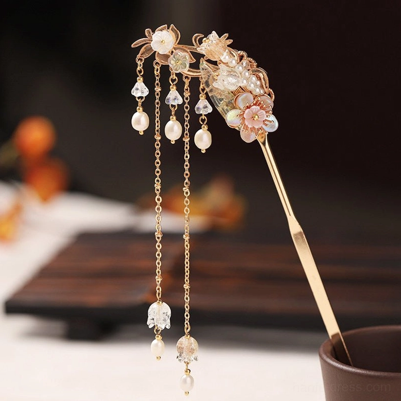Side view of a champagne gold Hanfu hair stick with multi-chain tassels, pink floral decorations, pearl accents, and crystal pendants
